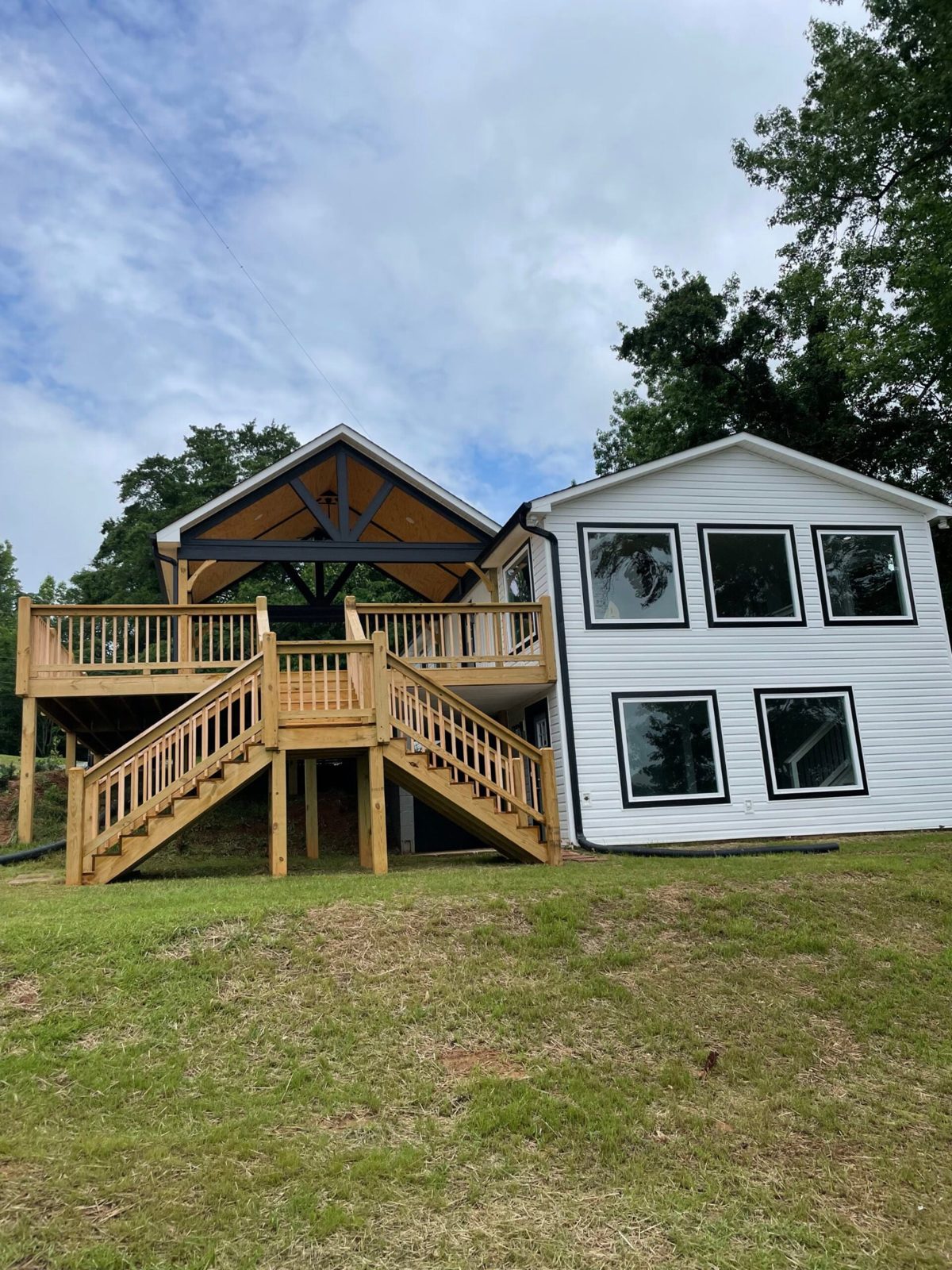 Custom pressure-treated deck with a covered gable pavilion and stairs