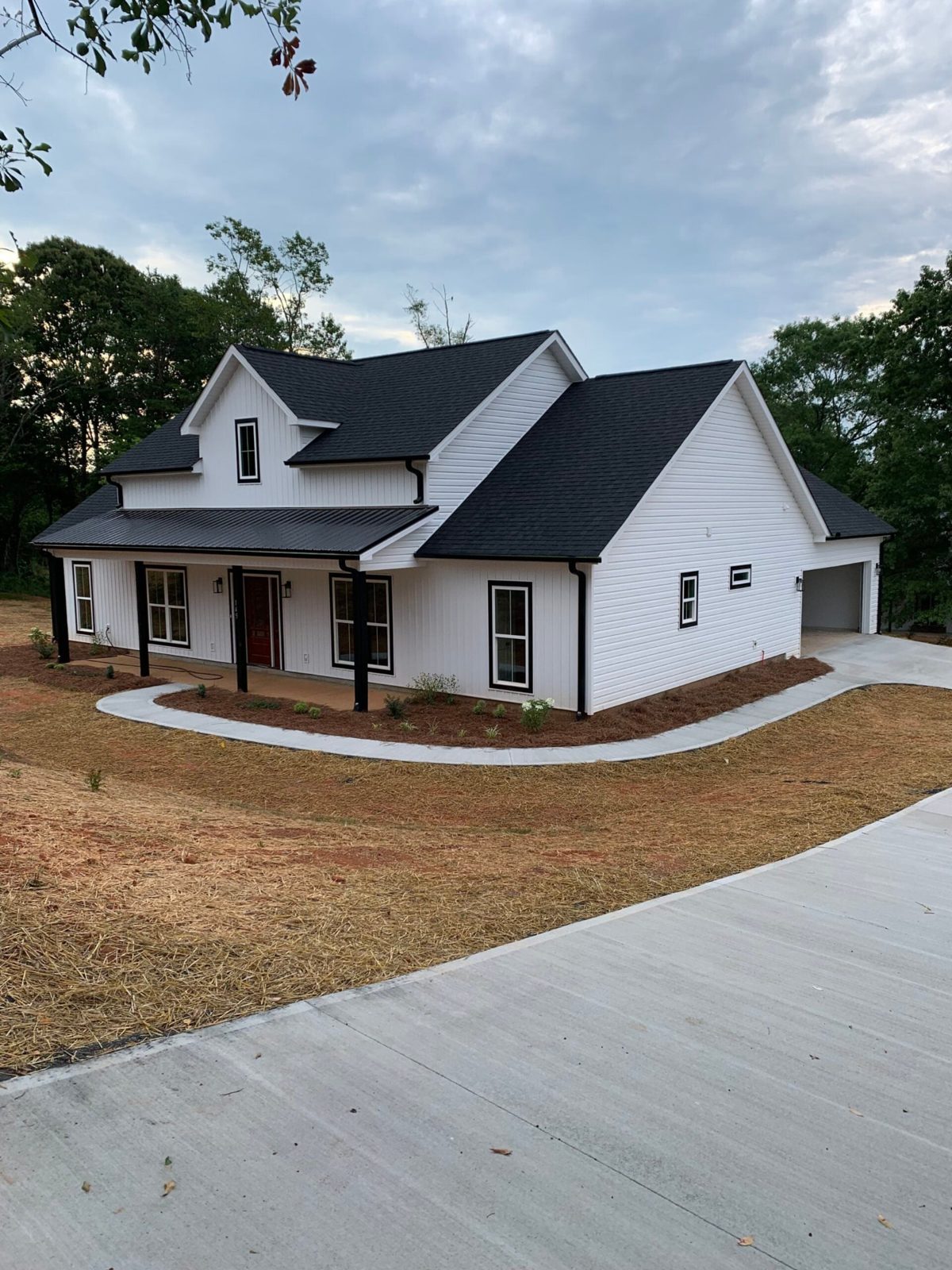 Modern farmhouse with a new black architectural shingle and metal roof